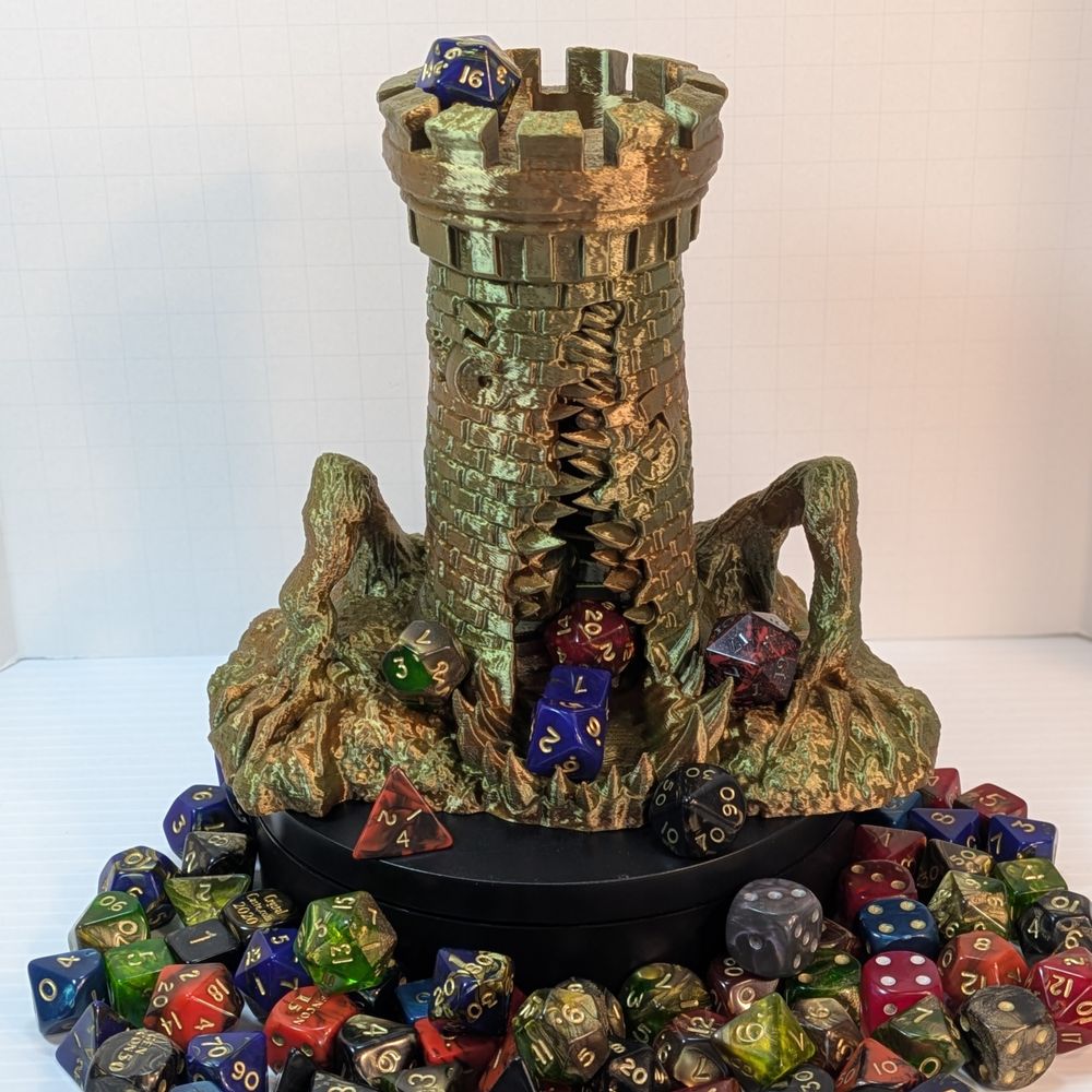 A 3D printed tower, printed in a shiny earth-tone gradient. The print is a dice tower, shaped like a stone tower, but it's a mimic. A toothy maw goes up the side, two windows look like eyes, and branches on either side look like arms pushing it up.