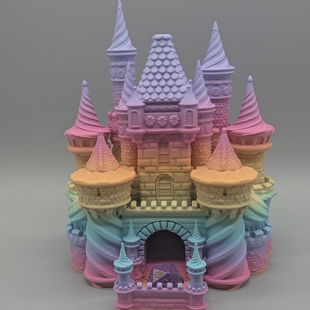 A 3d printed dice tower in the shape of a castle. It is in a pastel rainbow gradient that evokes thoughts of cotton candy.