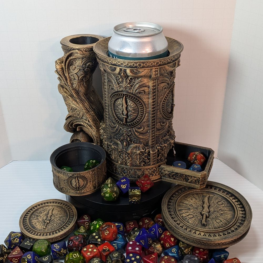 A "tankard" that acts as a dice tower, dice vault, and can holder. It's had brass Rub n Buff applied , and it's disassembled to show the dice tower in the handle, the can in the main cavity, the small dice vault at the side, and the screw-on lid.