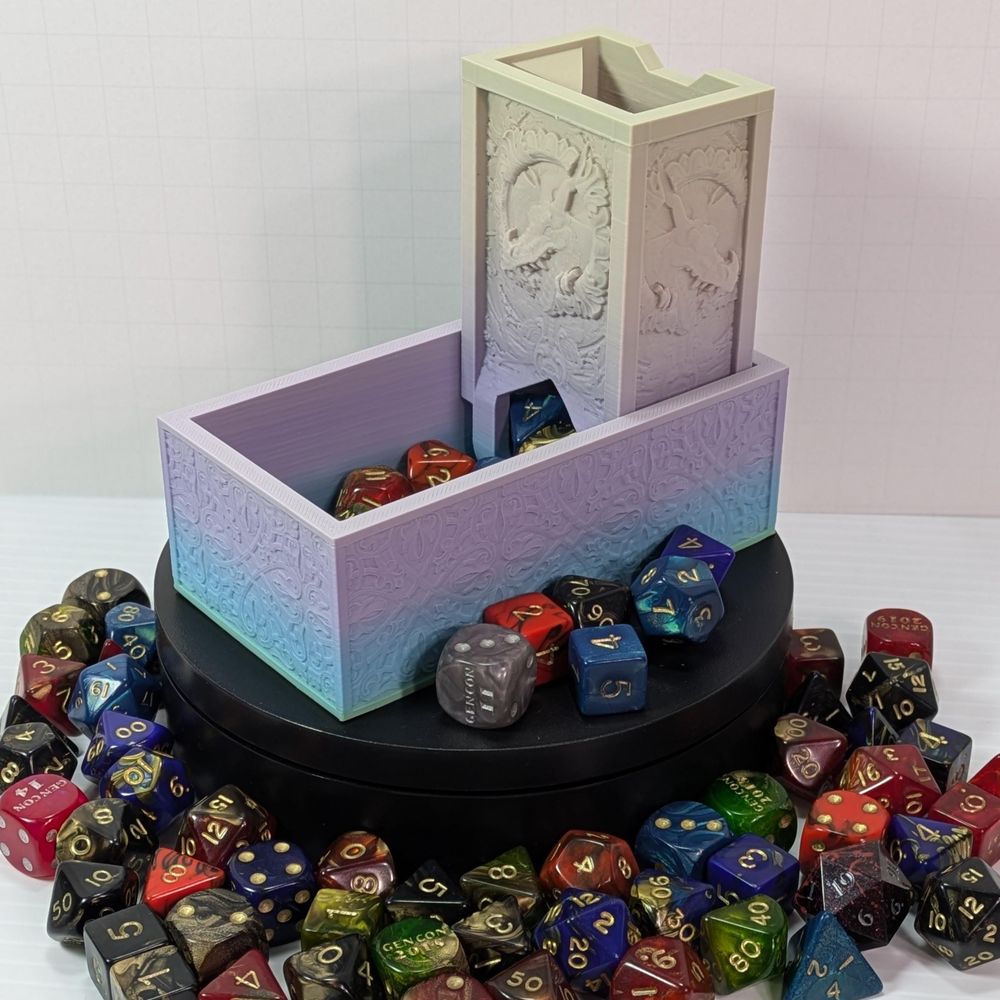 A very squared off 3d printed dice tower. It's essentially two rectangular boxes, one horizontal and one vertical in the end of the horizontal one. It's got artwork on a dragon on it, and it's printed in a pastel gradient.